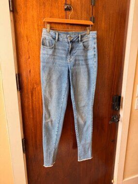 Light wash blue jeans with frayed hem